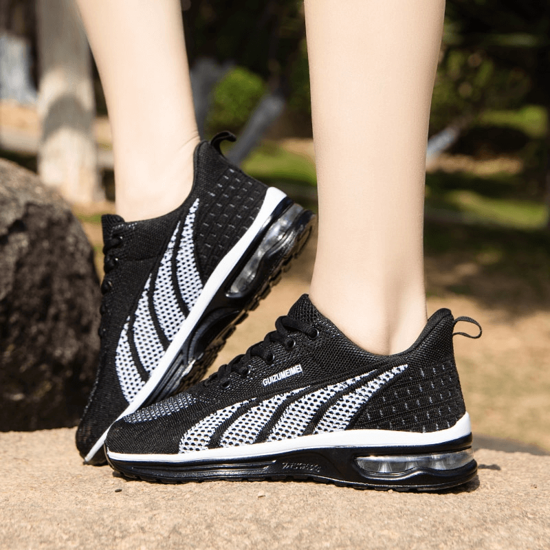 Woman wearing stylish mesh lace-up sneakers SF1414 with cushioning, black and white design, perfect for active lifestyles.